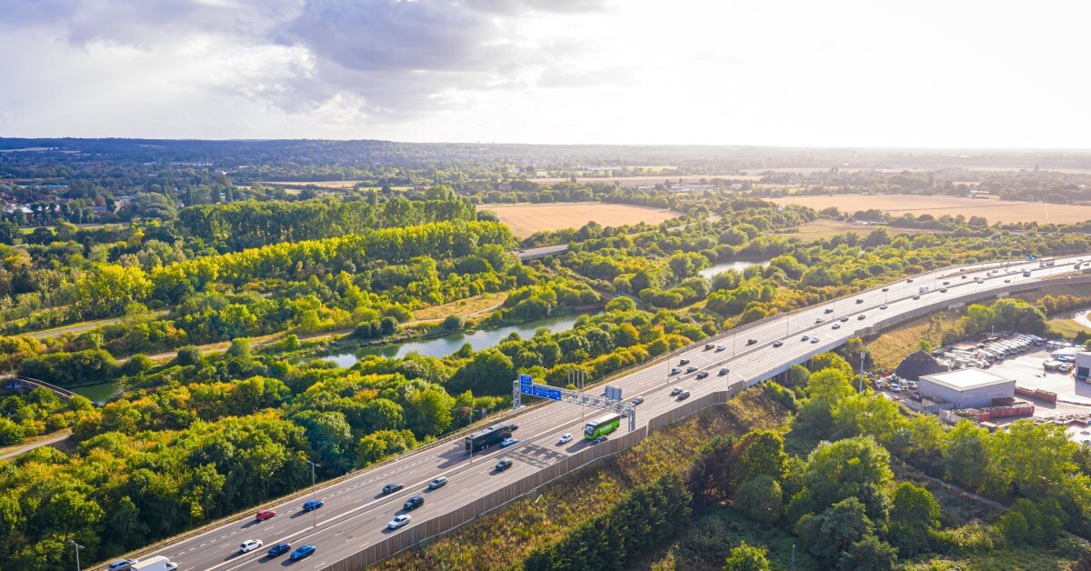 Aerial view of a UK motorway in the countryside, with cars driving on it