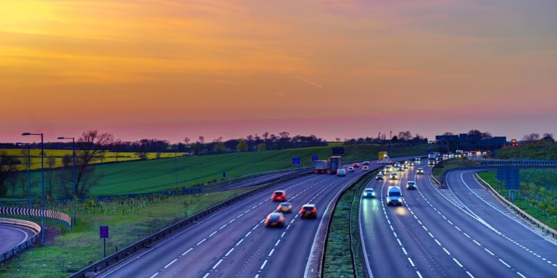 Blurred UK motorway with sunset in the background